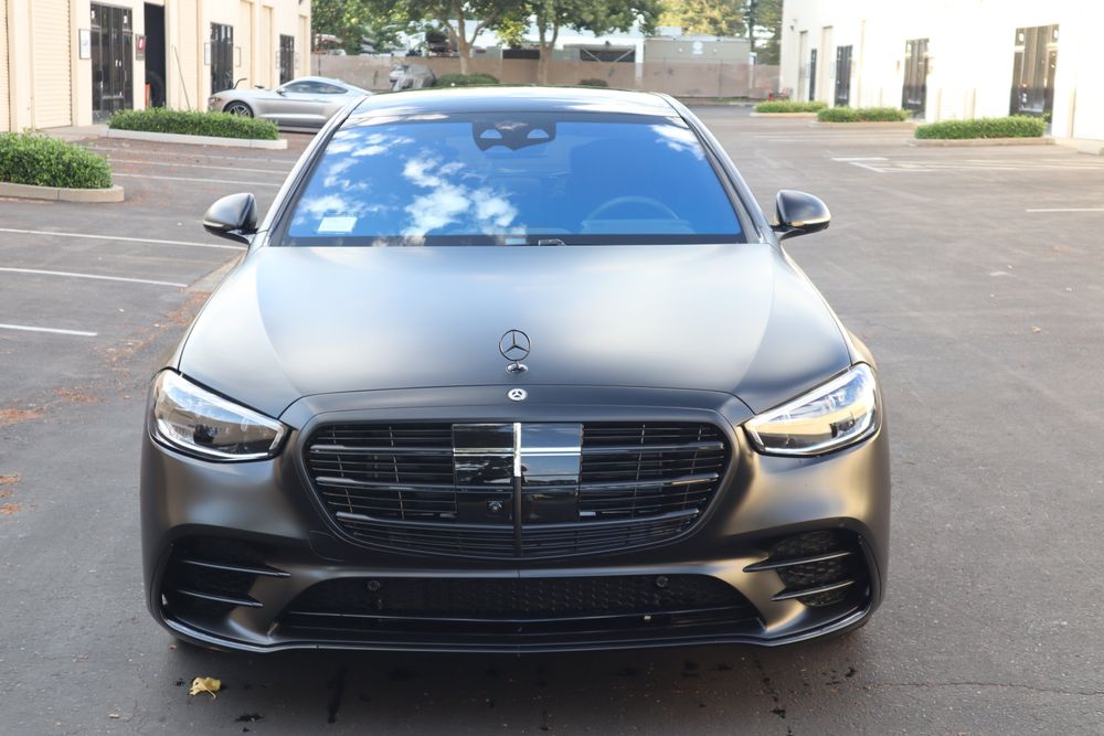 Front of a Mercedes-Benz S580 with a satin black wrap and full chrome delete by Drift Wraps