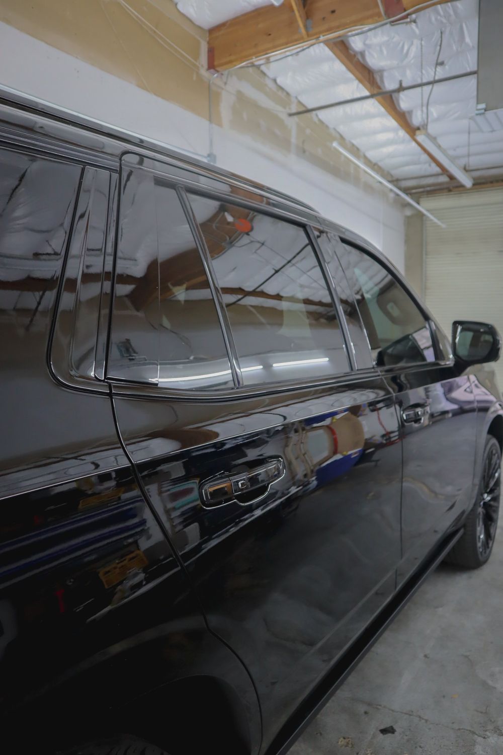 Blacked-out window trim on a Chevrolet Tahoe High Country with gloss black chrome delete by Drift Wraps