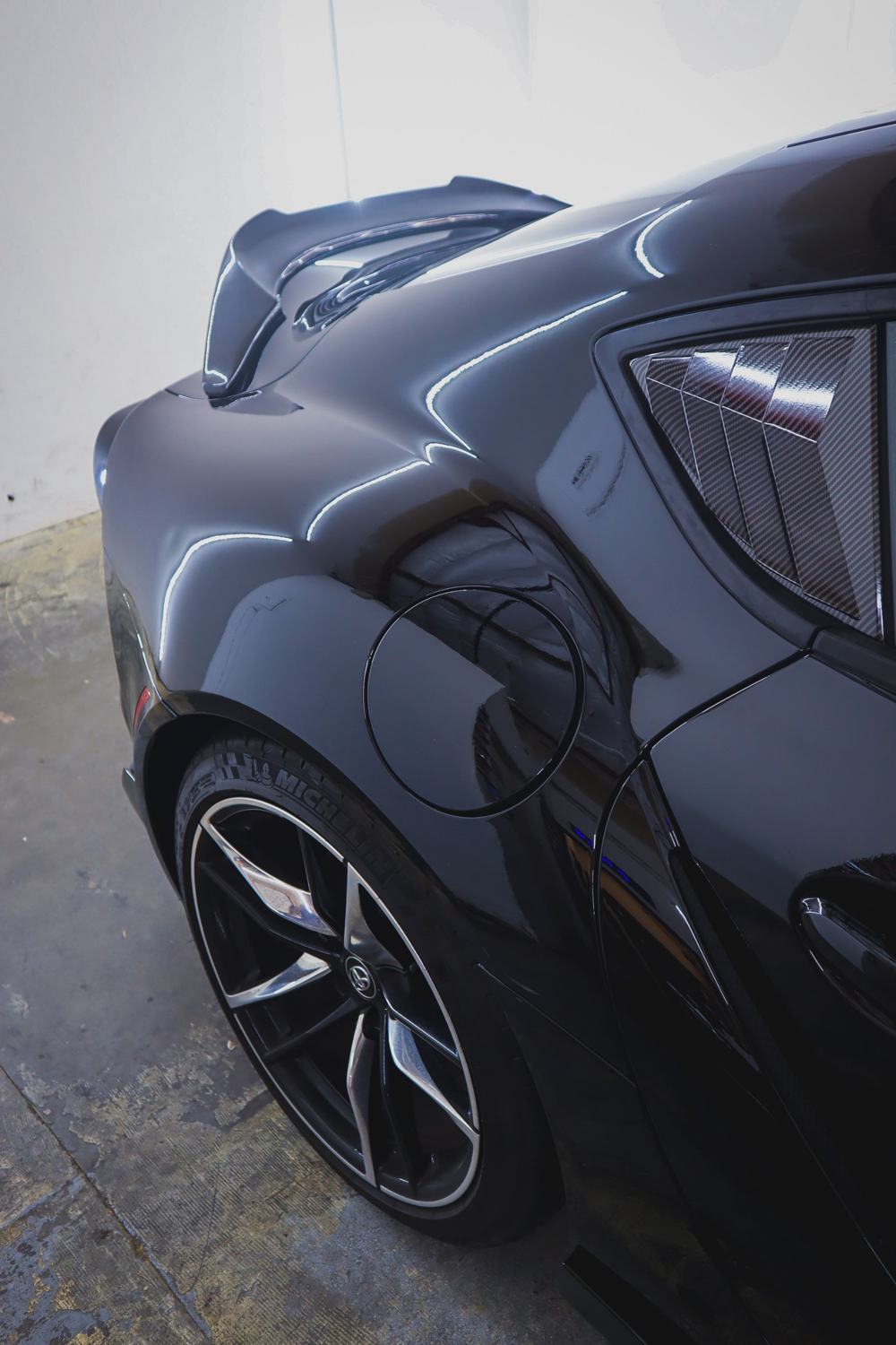 Rear quarter panel of a black 2020 Toyota GR Supra wrapped in Gloss Black Obsidian color PPF by Drift Wraps in Rancho Cordova