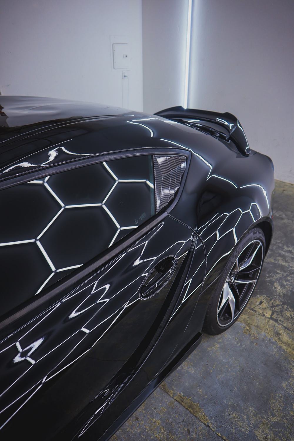 Gloss reflections on the side of a black 2020 Toyota GR Supra wrapped in Gloss Black Obsidian color PPF by Drift Wraps in Rancho Cordova