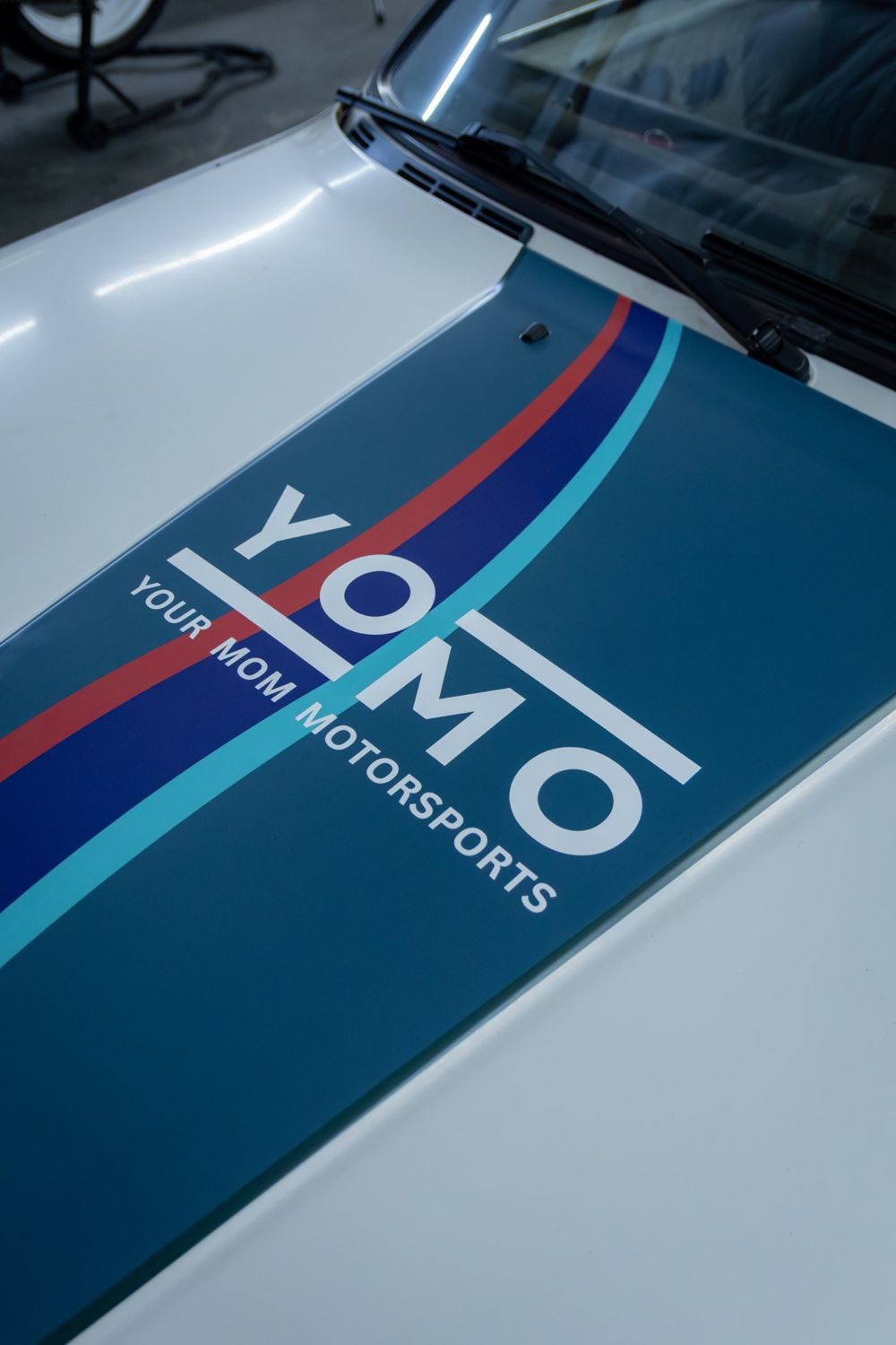 Hood stripe on a 1985 BMW 325e with a custom rally livery for Your Mom Motorsports by Drift Wraps