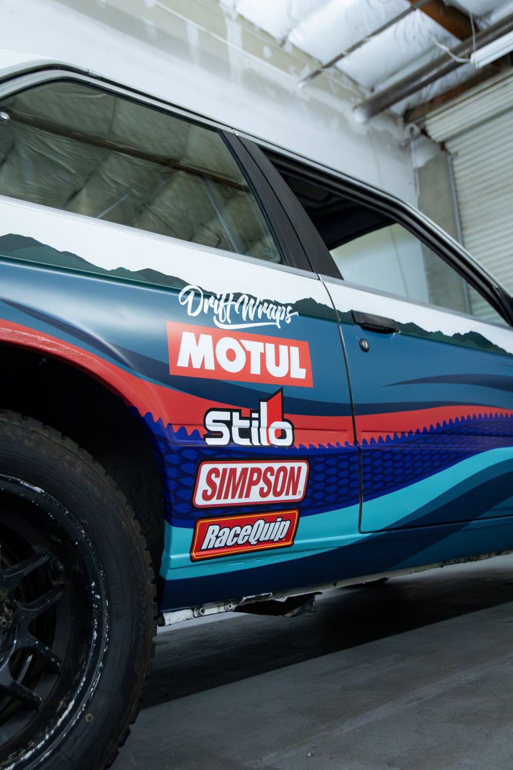 Side sponsor livery on a 1985 BMW 325e with a custom rally livery for Your Mom Motorsports by Drift Wraps