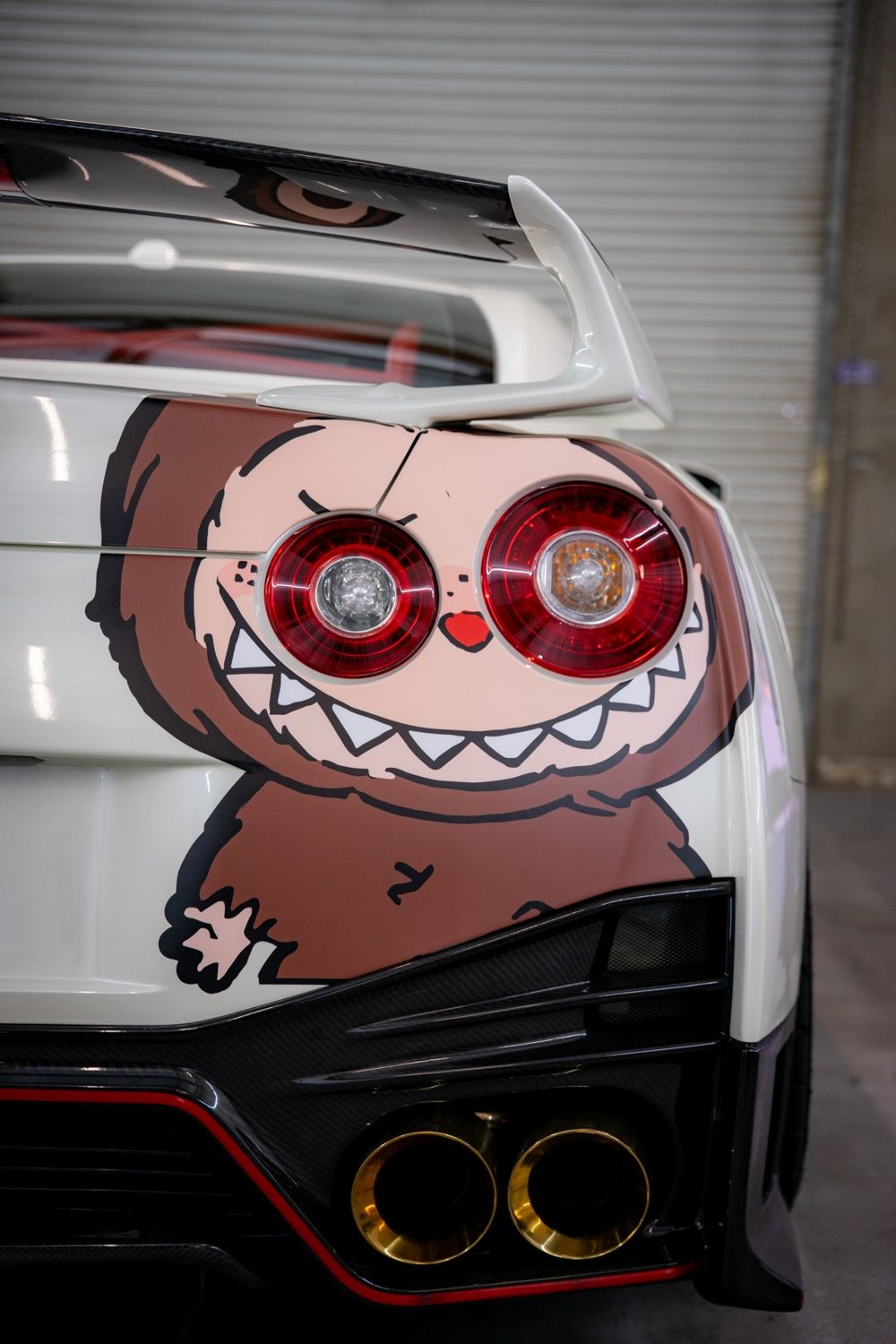 Taillight close-up of a Nissan GT-R R35 with a custom character graphic by Drift Wraps in Rancho Cordova