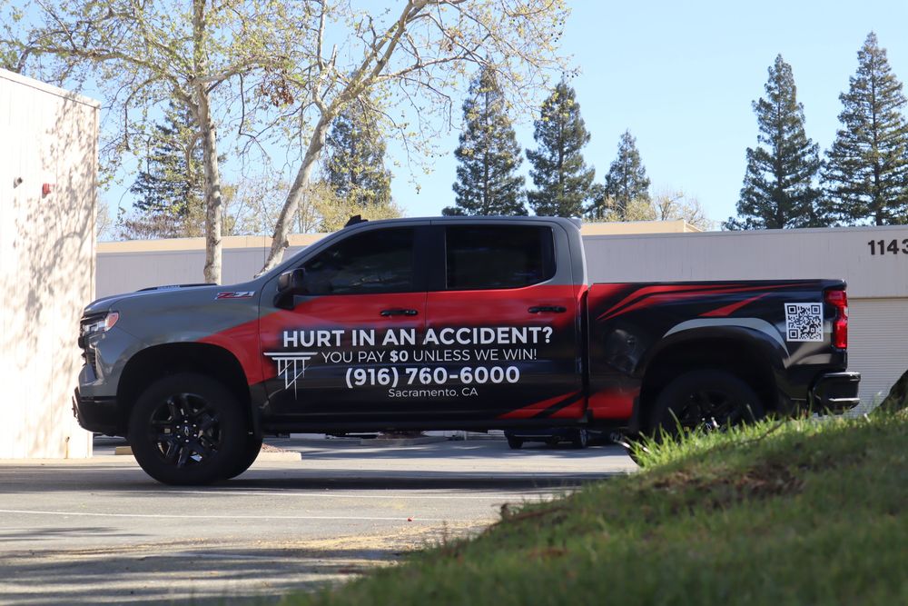 Side profile of an Alexander Cherny Personal Injury Lawyer Chevrolet Silverado Z71 with a custom design 2/3 wrap by Drift Wraps in Rancho Cordova