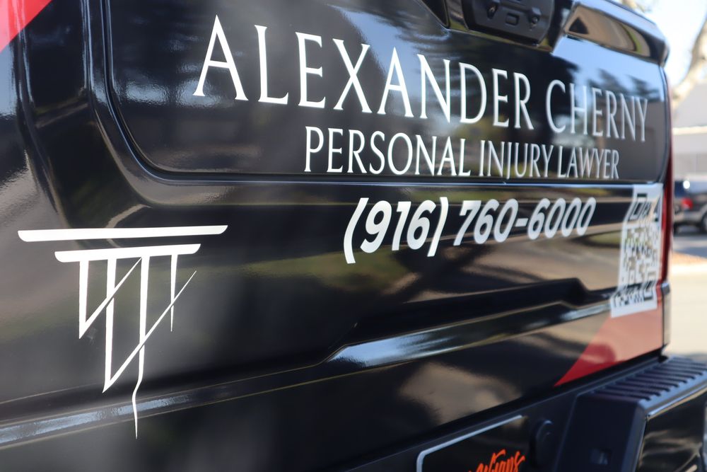 Close-up of tailgate lettering on an Alexander Cherny Personal Injury Lawyer Chevrolet Silverado Z71 with a custom design 2/3 wrap by Drift Wraps in Rancho Cordova