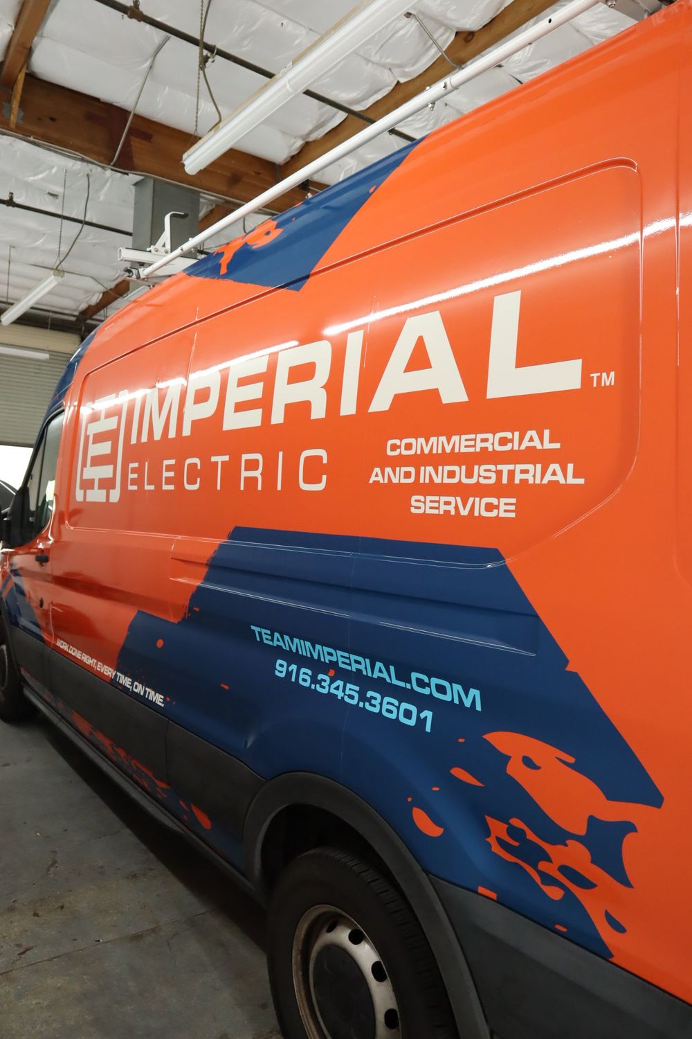 Rear quarter panel with website and phone number on an Imperial Electric Ford Transit van with a full custom design wrap by Drift Wraps in Rancho Cordova