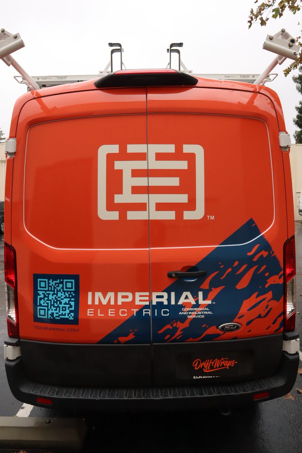 Rear doors with logo and QR code on an Imperial Electric Ford Transit van with a full custom design wrap by Drift Wraps in Rancho Cordova