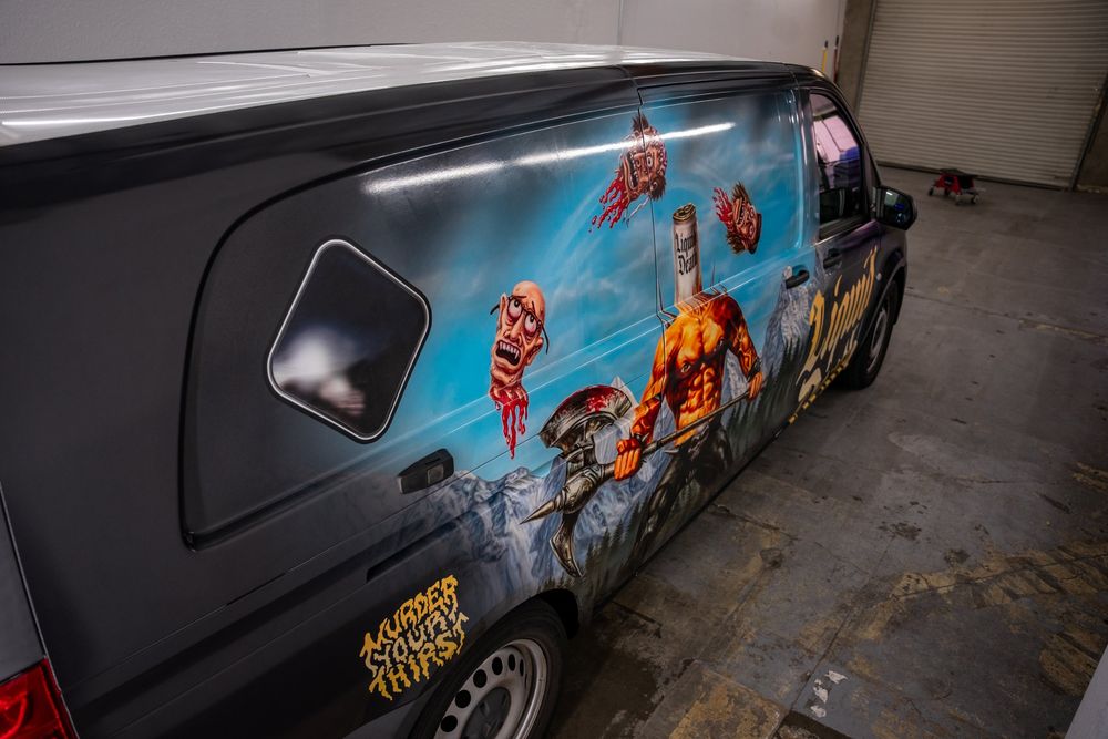 Illustrated mural on the side of a Liquid Death Mercedes-Benz Metris van with a themed full wrap by Drift Wraps in Rancho Cordova