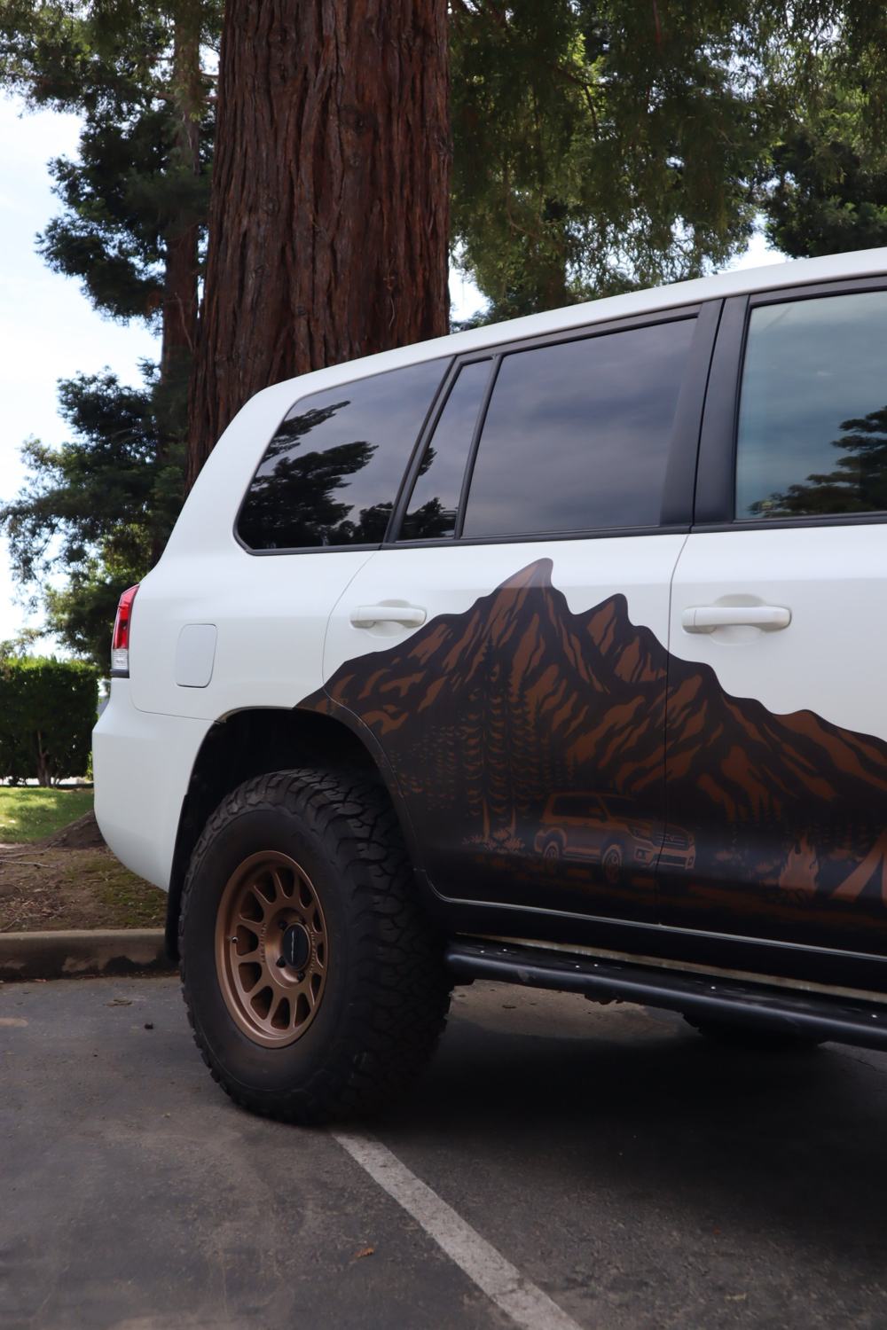 Side of a 2016 Toyota Land Cruiser with full-body matte PPF over custom graphics by Drift Wraps in Rancho Cordova with a custom mountain graphic