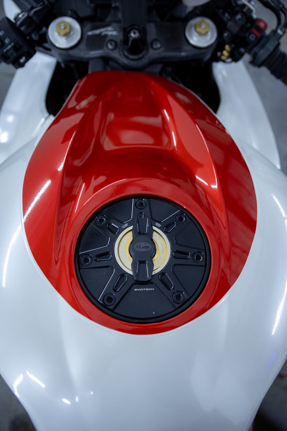 Tank of a Honda CBR with a custom white and red wrap in 3M Gloss Dragon Fire Red and Avery Dennison Gloss White Pearl by Drift Wraps