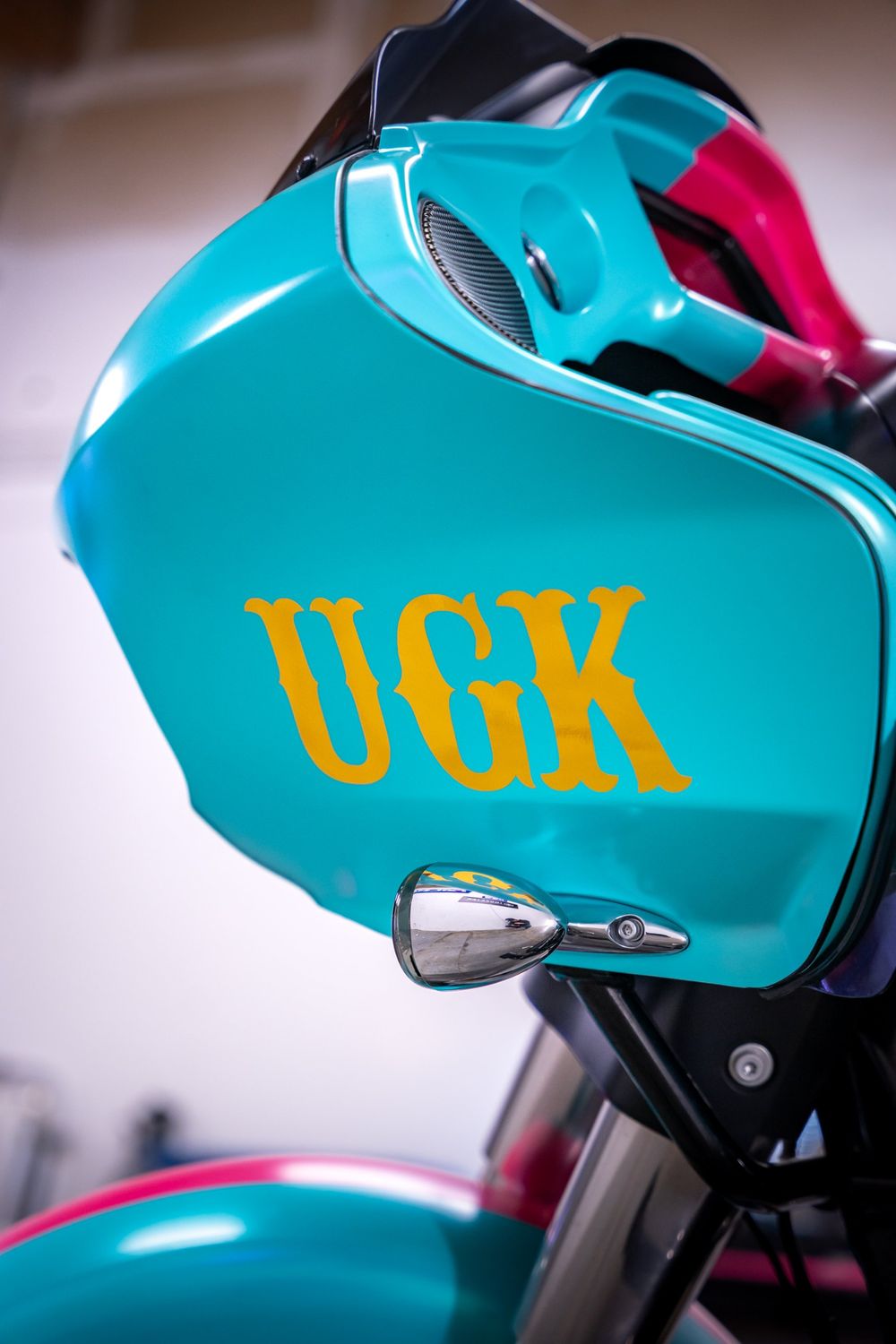 Pink side of the tank on a Harley-Davidson Road Glide with a half pink, half teal themed wrap by Drift Wraps