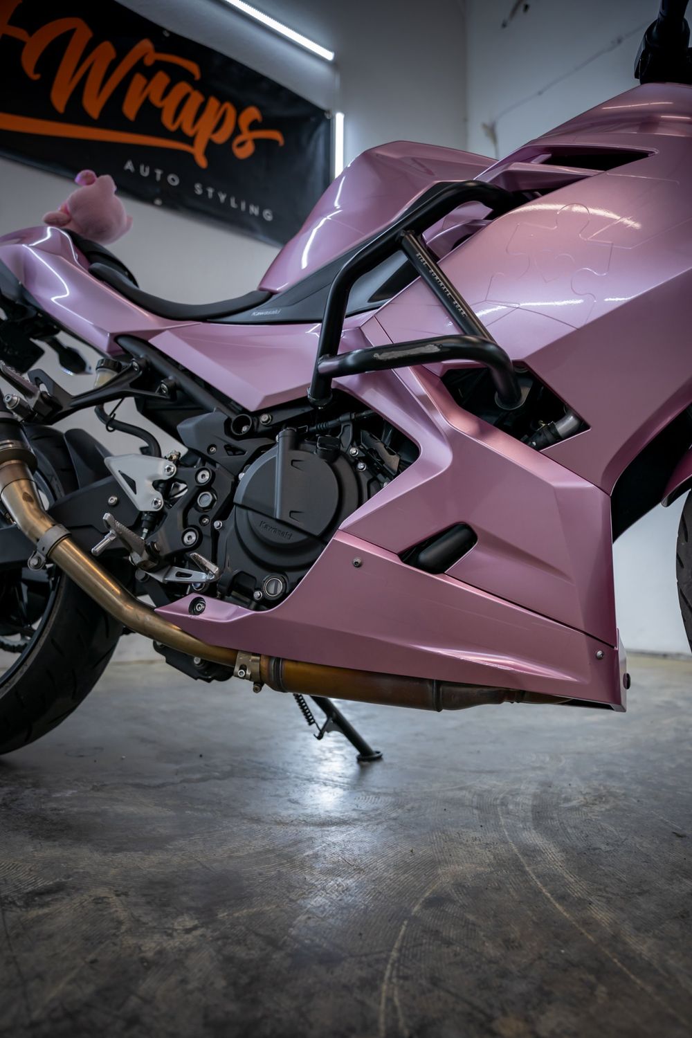 Lower fairing of a Kawasaki Ninja wrapped in TinyBot Metal Paint Passion Pink by Drift Wraps