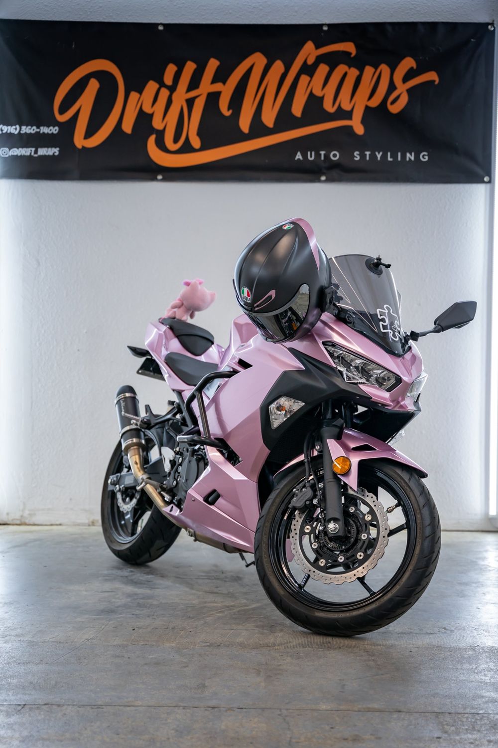 Front three-quarter view of a Kawasaki Ninja wrapped in TinyBot Metal Paint Passion Pink by Drift Wraps