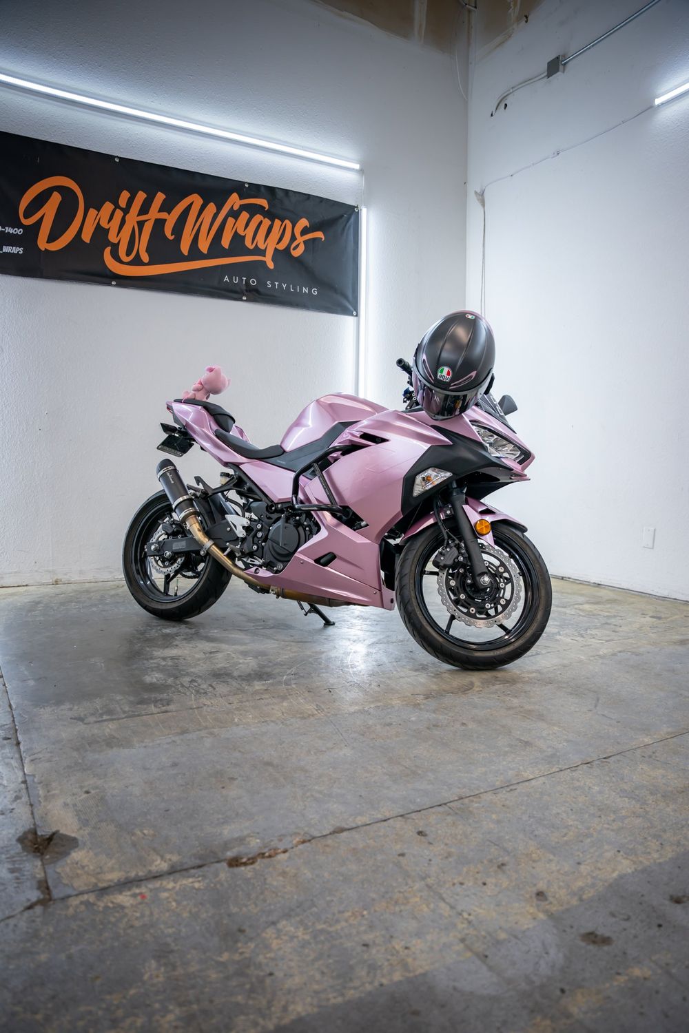 Side view of a Kawasaki Ninja wrapped in TinyBot Metal Paint Passion Pink by Drift Wraps
