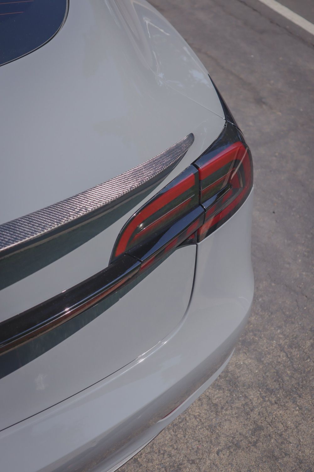 Taillight close-up on a Tesla Model 3 wrapped in 3M High Gloss Nardo Gray by Drift Wraps