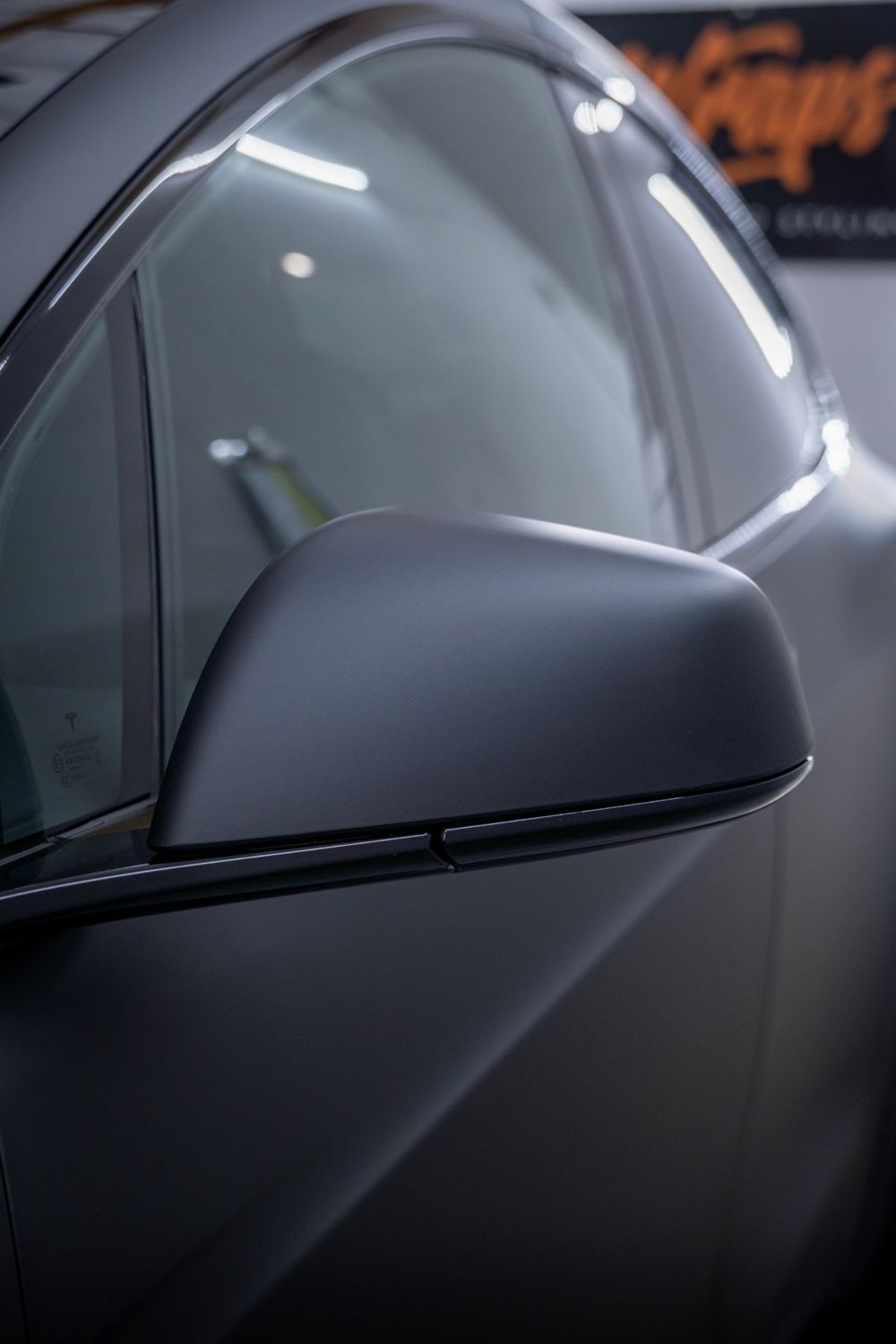 Mirror close-up on a Tesla Model X wrapped in 3M Dead Matte Black by Drift Wraps