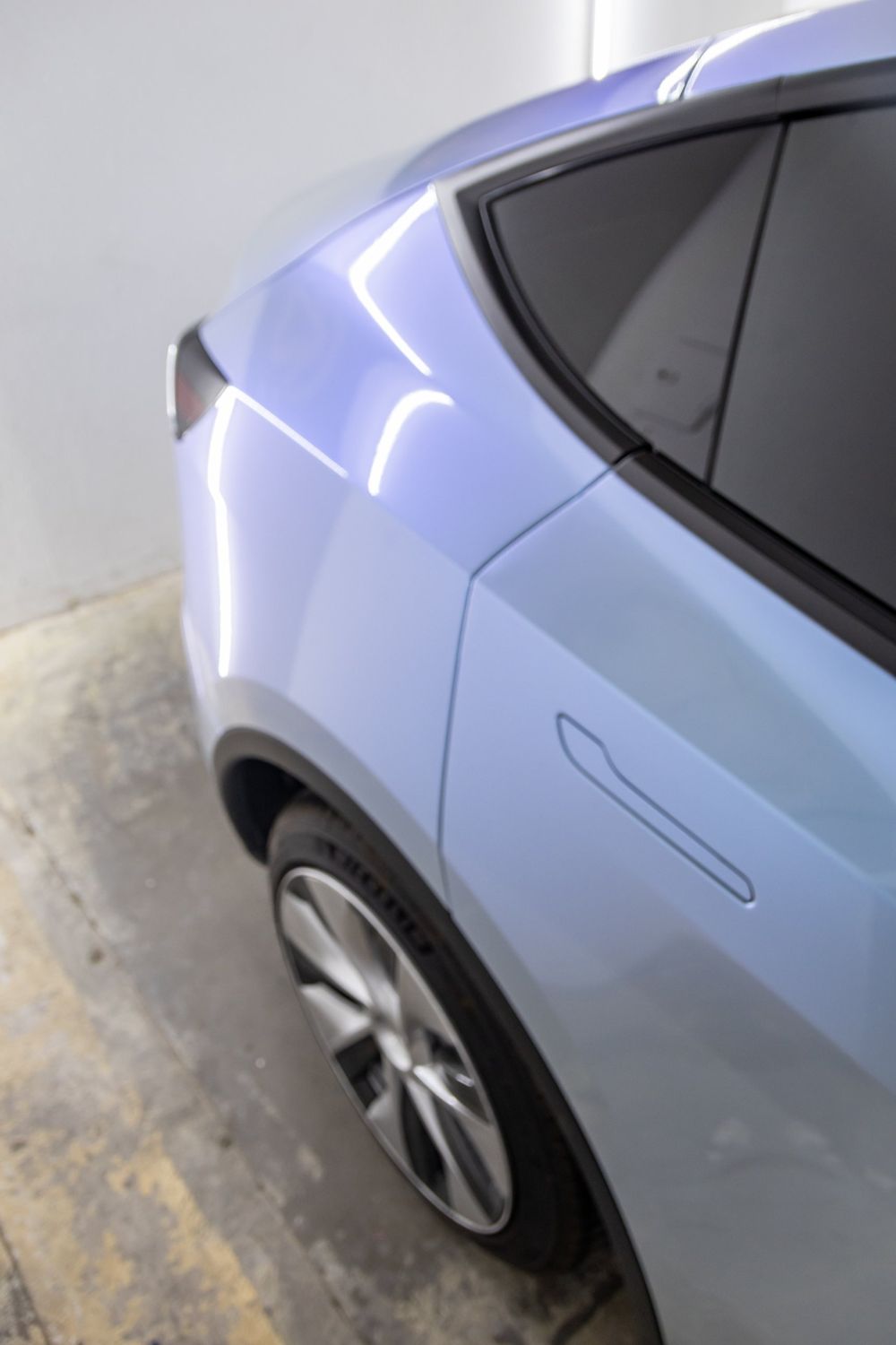 Rear door and quarter panel of a Tesla Model Y wrapped in TeckWrap Gloss Azure Maya Blue by Drift Wraps