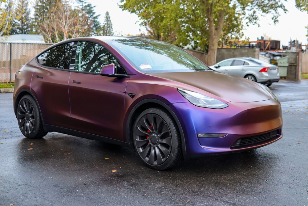 Front three-quarter view of a Tesla Model Y wrapped in Avery Dennison Satin Roaring Thunder by Drift Wraps