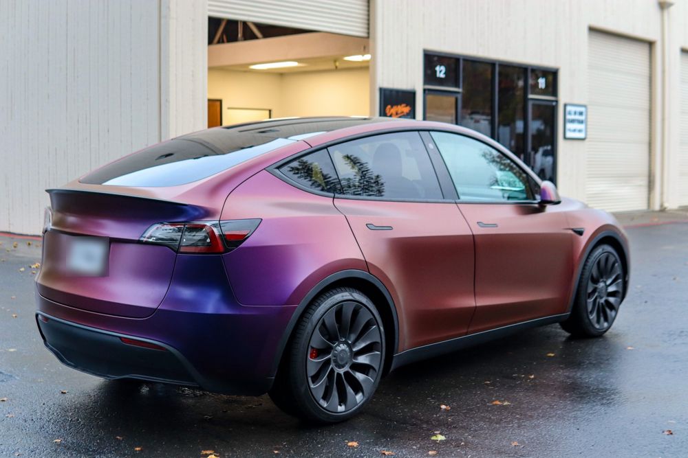 Rear three-quarter view of a Tesla Model Y wrapped in Avery Dennison Satin Roaring Thunder by Drift Wraps