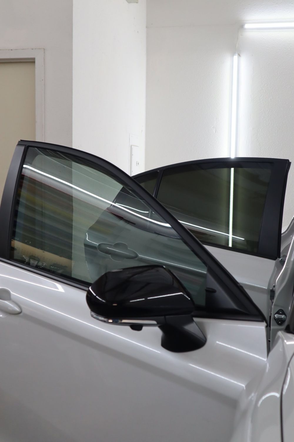 Tinted front and rear door glass on a white Toyota Camry with LLumar ceramic window tint by Drift Wraps in Rancho Cordova