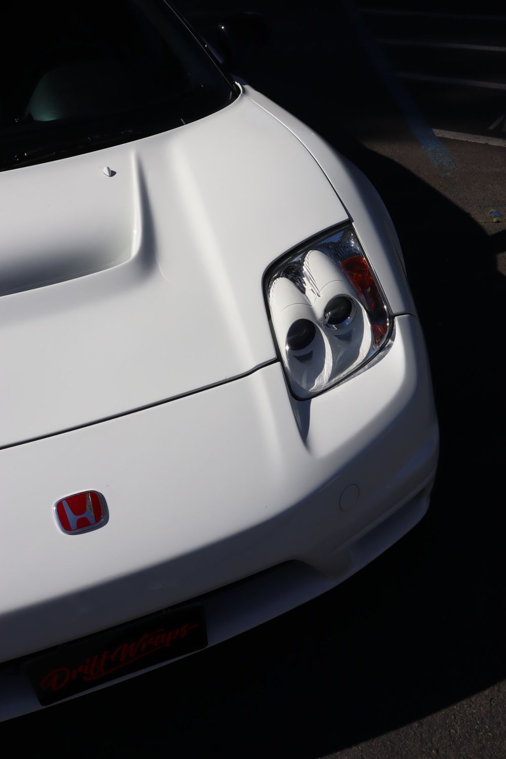 Front and headlight of a white Acura NSX with LLumar ceramic window tint by Drift Wraps in Rancho Cordova