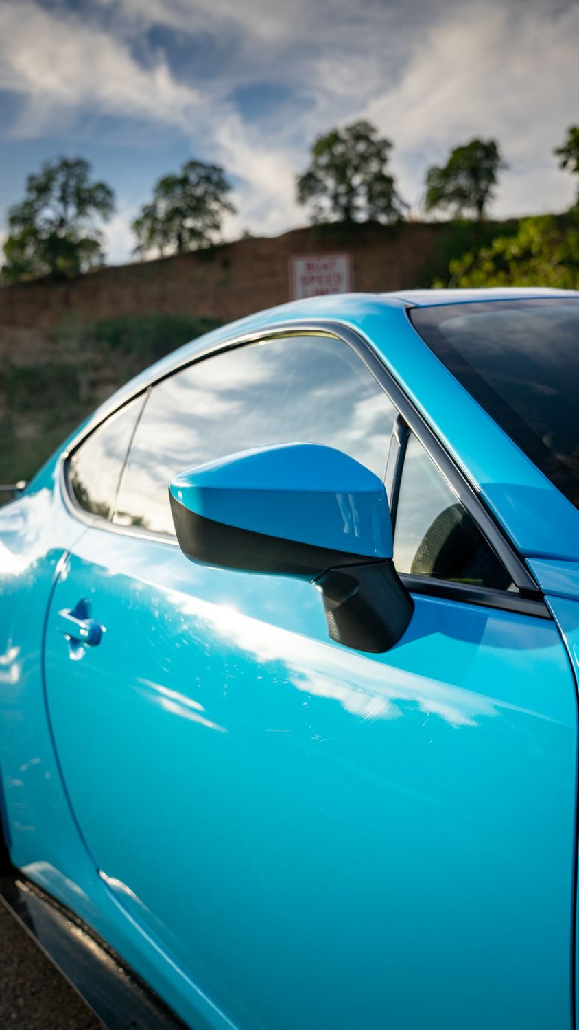 Side mirror and door of a 2019 Toyota 86 wrapped in Aura Ultra Gloss Laguna Blue vinyl by Drift Wraps in Rancho Cordova
