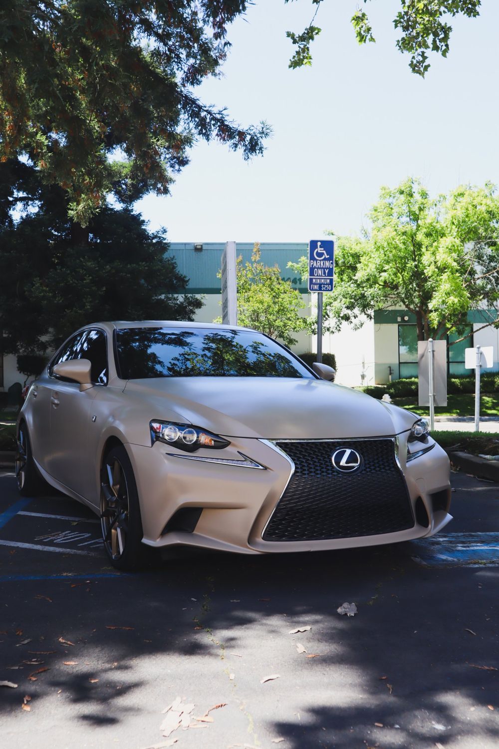 Front three-quarter view of a 2016 Lexus IS F Sport wrapped in KPMF Satin Stealth Tundra vinyl by Drift Wraps in Rancho Cordova