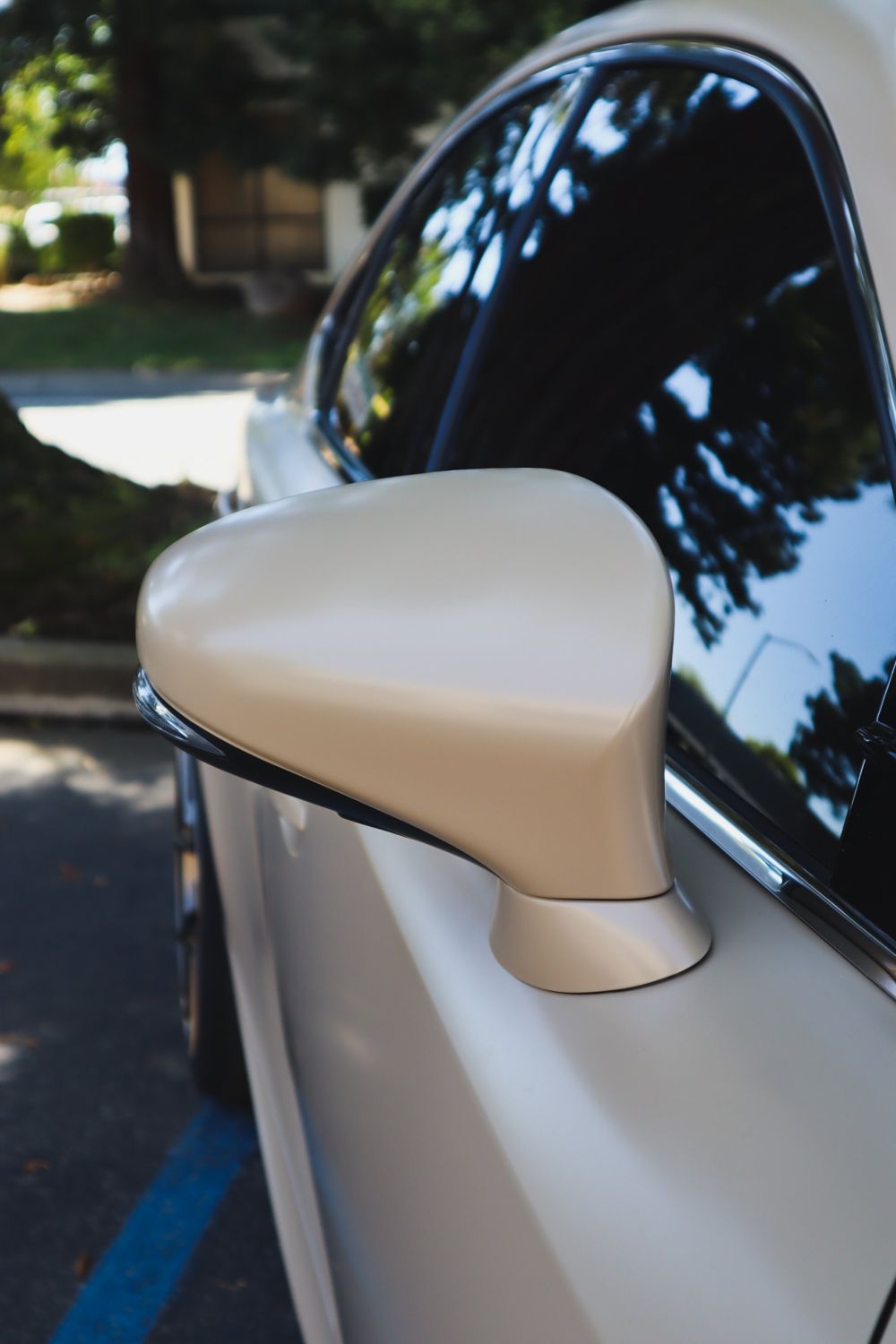 Side mirror close-up on a 2016 Lexus IS F Sport wrapped in KPMF Satin Stealth Tundra vinyl by Drift Wraps in Rancho Cordova