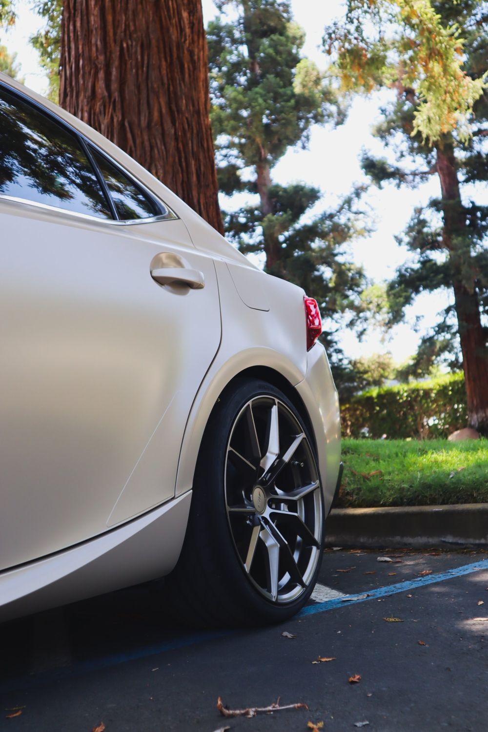 Rear quarter of a 2016 Lexus IS F Sport wrapped in KPMF Satin Stealth Tundra vinyl by Drift Wraps in Rancho Cordova