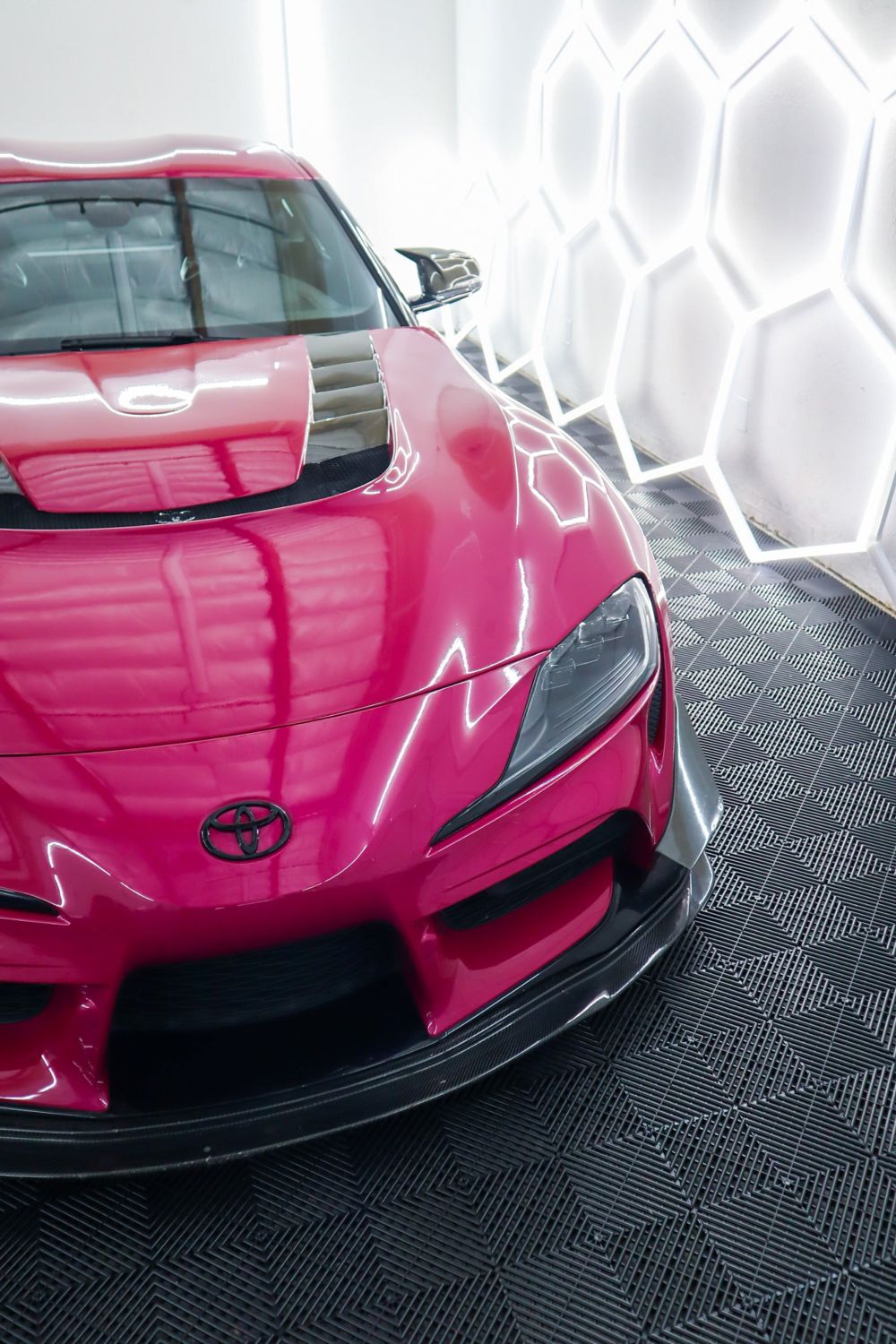 Hood close-up on a 2022 Toyota GR Supra wrapped in 3M High Gloss Ruby Rosso vinyl by Drift Wraps in Rancho Cordova