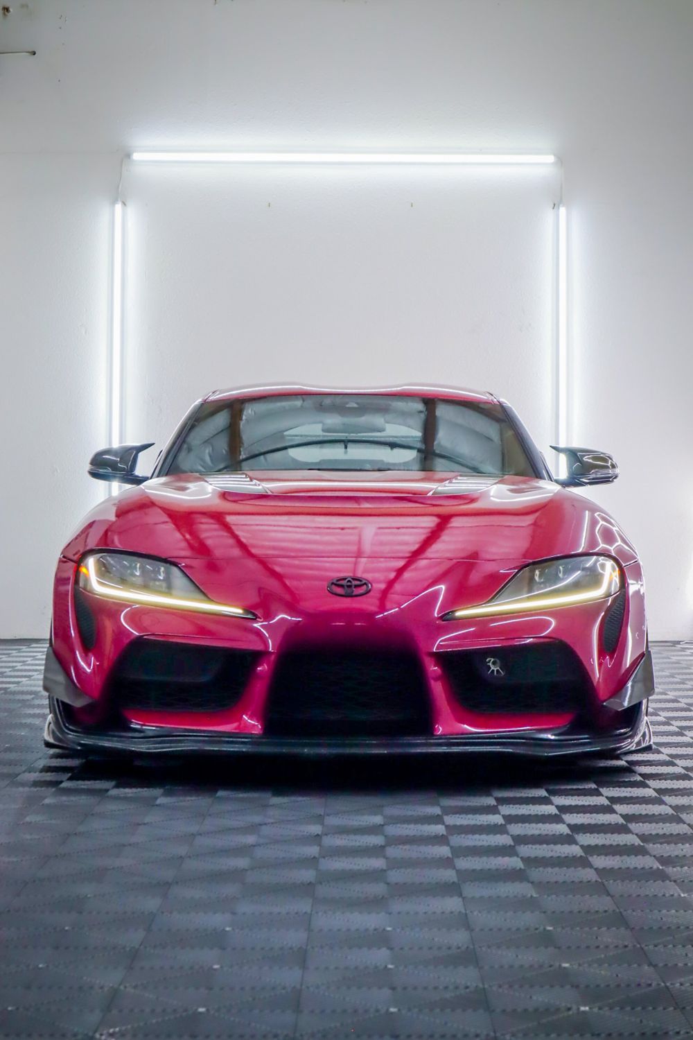 Headlights on a 2022 Toyota GR Supra wrapped in 3M High Gloss Ruby Rosso vinyl by Drift Wraps in Rancho Cordova