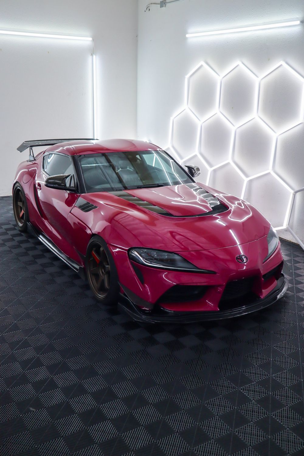 2022 Toyota GR Supra wrapped in 3M High Gloss Ruby Rosso vinyl by Drift Wraps in Rancho Cordova in the studio